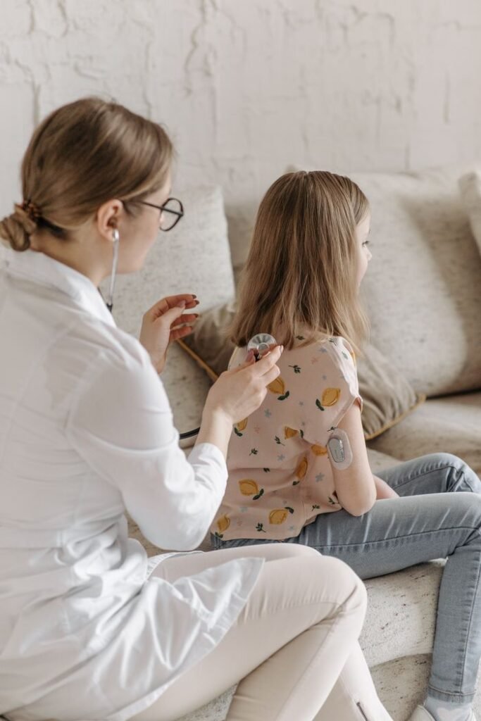 pexels-photo-7653112-7653112 Doctor conducting a health check on a young girl managing diabetes at home.